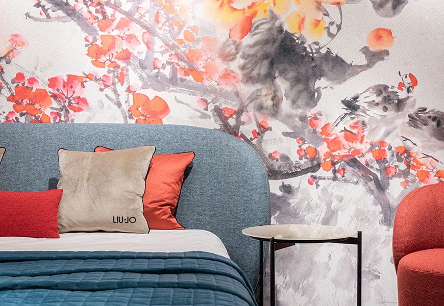 a bed with a blue blanket and pillows