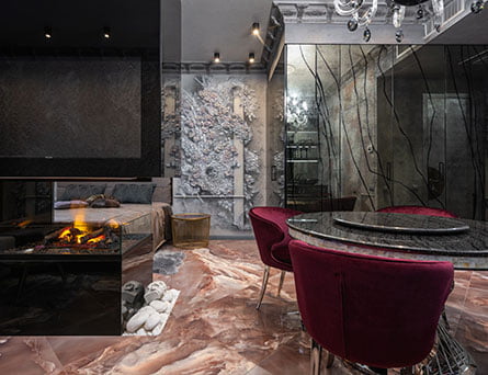 a room with a fireplace and chairs