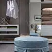 a room with a round blue ottoperson