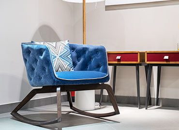 a blue chair with pillow